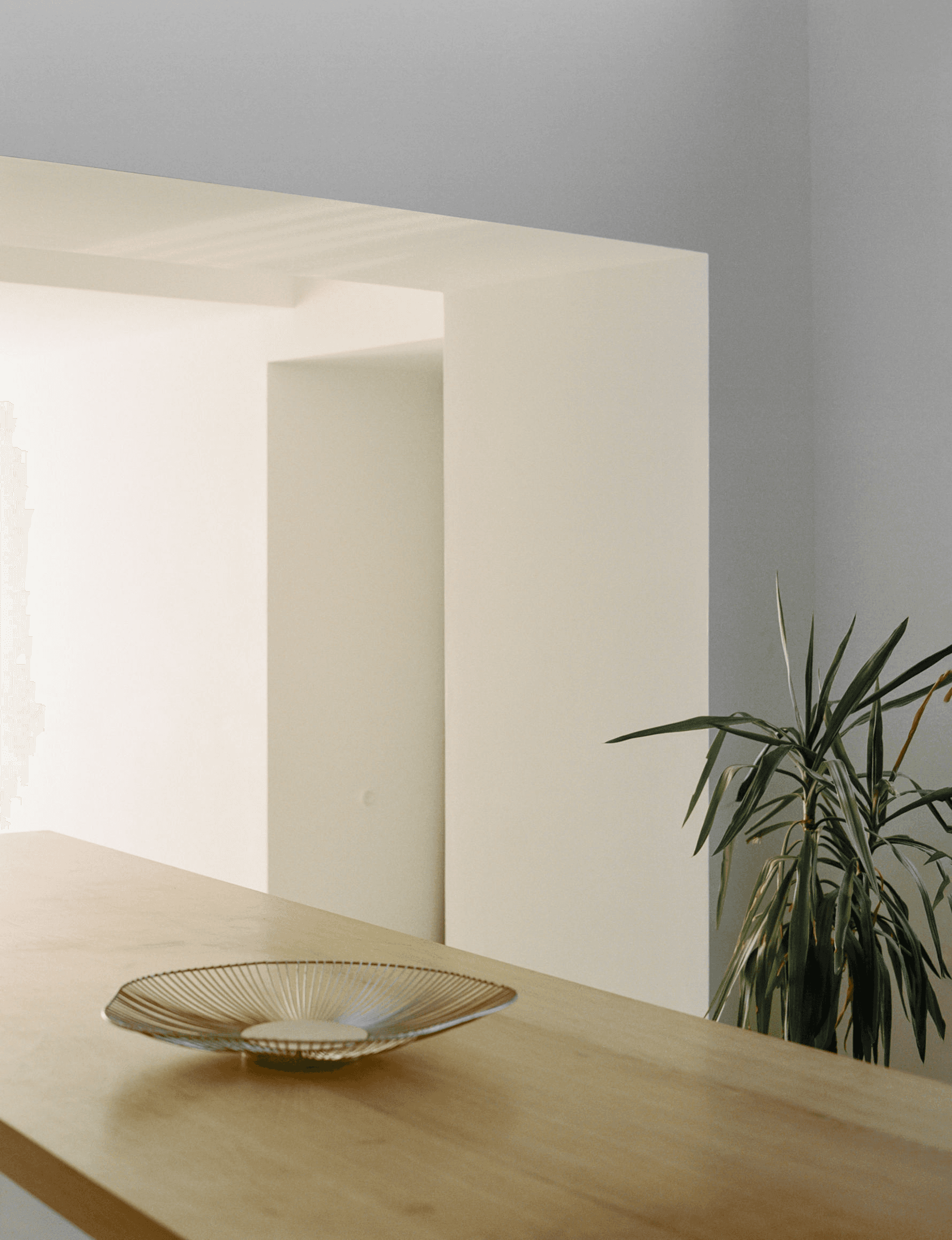 Minimal interior with an oak table and a glass bowl